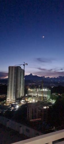 a view of a city at night with a building at Inspiria Condo Units beside Abreeza Mall Davao in Davao City
