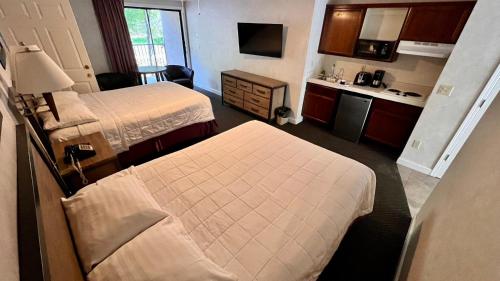 a hotel room with two beds and a kitchen at Yosemite View Lodge in El Portal