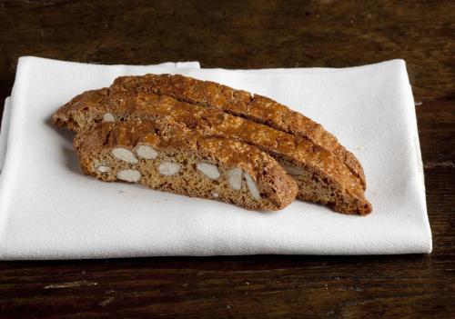 a piece of bread sitting on a white plate at Hotel Albergo Villa Marta in Lucca