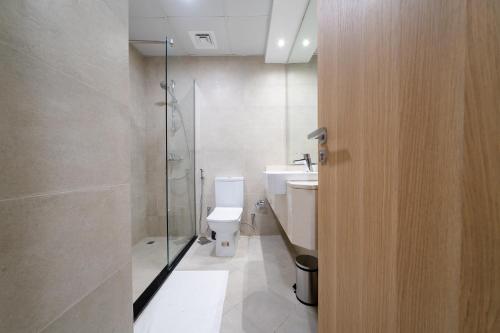 a bathroom with a toilet and a sink and a shower at ALH Vacay - Modern studio vacation home in Dubai