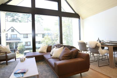 a living room with a couch and a table at Hérisson - A Valley Chalets Signature Residence in Hakuba