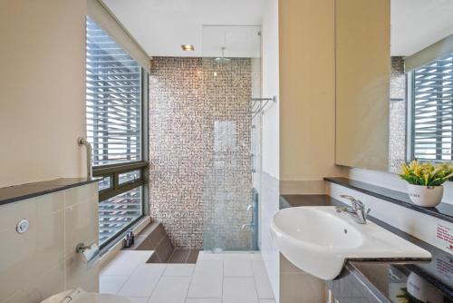 a bathroom with a sink and a shower at Greystone Swiss Garden Residence in Kuala Lumpur