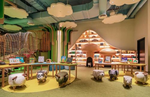a room with stuffed animals and a building with clouds at Regent Phu Quoc in Phu Quoc