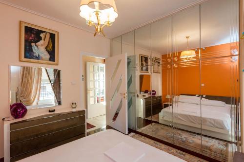 a bedroom with a bed and a glass wall at Flisvos Elite Seafront Luxury Apartment in Athens