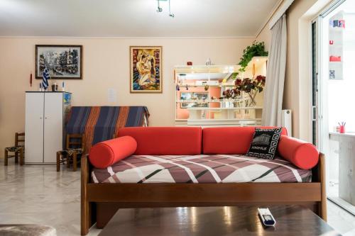 a living room with a red couch in a room at Flisvos Elite Seafront Luxury Apartment in Athens