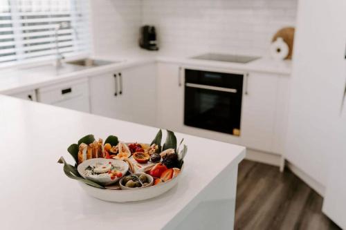 a bowl of vegetables sitting on a counter in a kitchen at Water's Edge in Culburra Beach