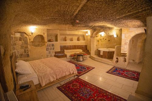 a bedroom with a bed in a stone room at Pietra Cave Suites in Ürgüp