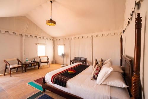 a bedroom with a large bed in a room at Helsinki Desert Camp in Jaisalmer