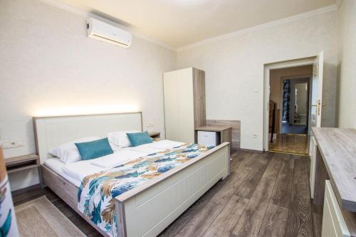 a bedroom with a large bed in a room at Járja Panzió in Hajdúszoboszló