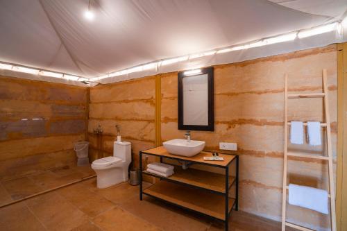 a bathroom with a sink and a toilet at Helsinki Desert Camp in Jaisalmer