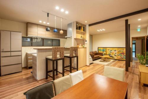 a kitchen and living room with a table and chairs at Traditional house/200sqm/good location/5BR/15Max in Kinugasa