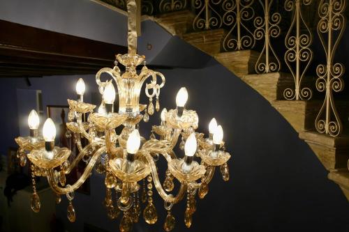 a large gold chandelier with candles on a table at Madama Residence in Nicosia