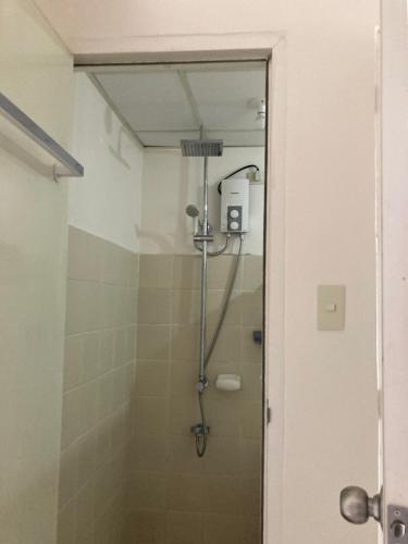 La salle de bains est pourvue d'une douche et d'une porte en verre. dans l'établissement B123 Unit 1852 Prime Residences Tagaytay, à Tagaytay