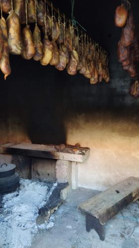 a bunch of loaves of bread hanging from a wall at Aldeia de Moura Morta in Moura Morta