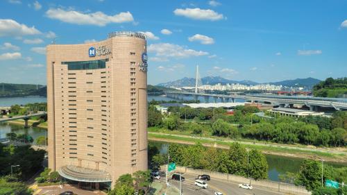 a tall building next to a river and a bridge at Niagara Hotel in Seoul