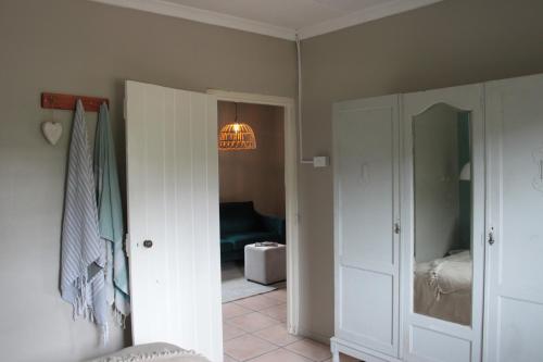 a hallway with a room with a bed and a light at Matroosbergstasie Karoohuisies in Matroosberg Private Nature Reserve