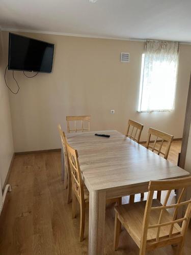 a dining room with a wooden table and chairs at Atpūtas māja Sigulda in Sigulda