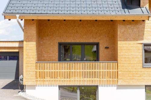 a brick house with a black roof at Haus Amatschon in Brand