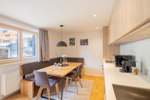 a kitchen and dining room with a table and chairs at Haus Amatschon in Brand