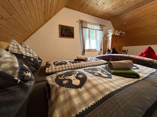 a bedroom with two beds with blankets and pillows at Cozy holiday home in Prebl with a view in the Klippitzt rl ski area in Prebl
