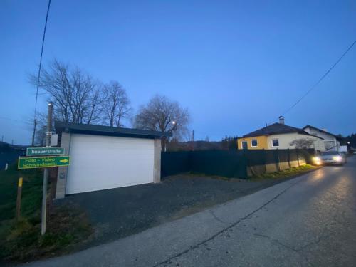 a white garage on the side of a street at Ferienhaus Sausalblick in Großklein