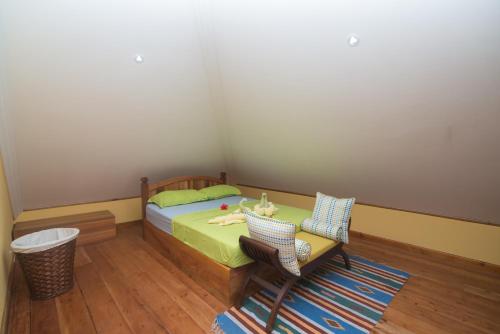 a bedroom with a bed and a table and chairs at Pension Michel Villa Roche Bois in La Digue