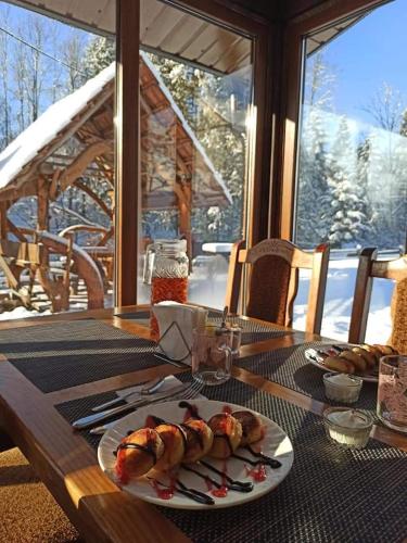 a table with a plate of food on top at Zatishok Bilya Richky in Pilipets