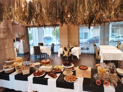 a table with many different types of food on it at Hotel Bienestar Moaña in Moaña