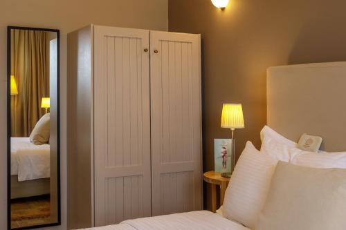 a bedroom with a bed and a large mirror at Agiannorema in Arachova