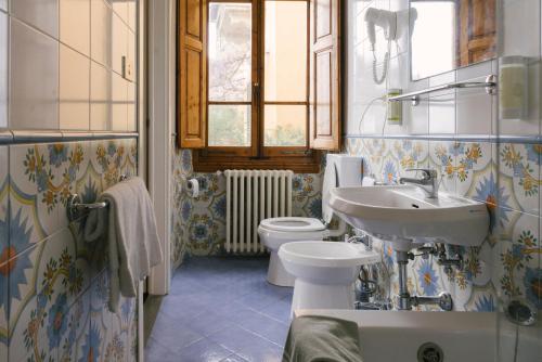 a bathroom with a sink and a toilet at Pensione Bencist&agrave; in Fiesole