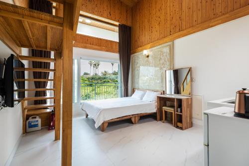 a bedroom with a bed and a large window at Aewol Oceanstay in Jeju