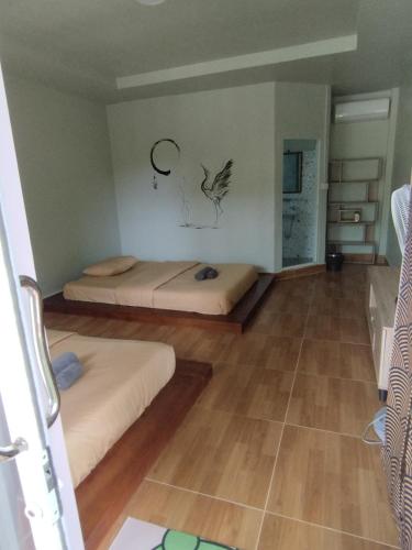 a room with two beds and a wall with drawings on the wall at WHITE SAND ARK RESORT in Koh Rong Island