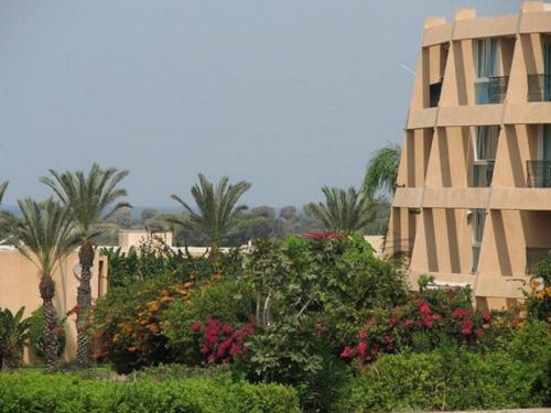 a building with a bunch of flowers in front of a building at Caesarea Vacation Rooms in Caesarea