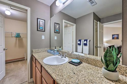 a bathroom with a sink and a large mirror at Walk to Lake Townhome with Hot Tub in Afton! in Afton