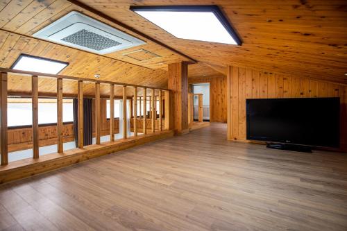 a large living room with a flat screen tv at Aewol Oceanstay in Jeju
