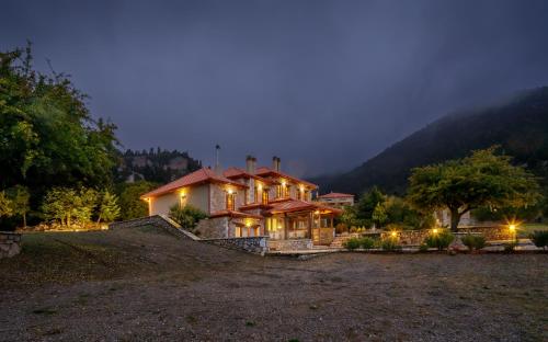 a large house at night with a mountain at Agiannorema in Arachova