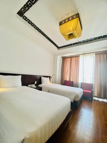 Postel nebo postele na pokoji v ubytování Cherish Hue Hotel