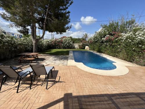a patio with chairs and a swimming pool at Montenegro - BTB in Denia