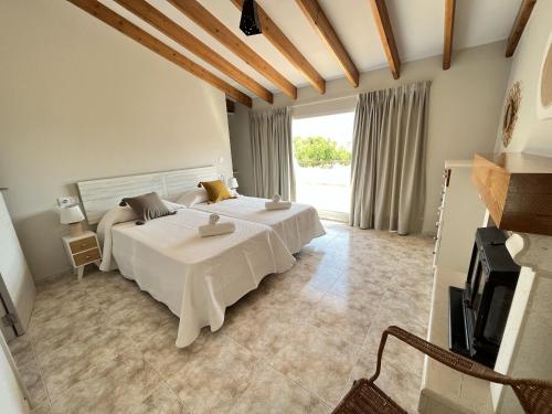 a bedroom with two beds and a large window at Montenegro - BTB in Denia