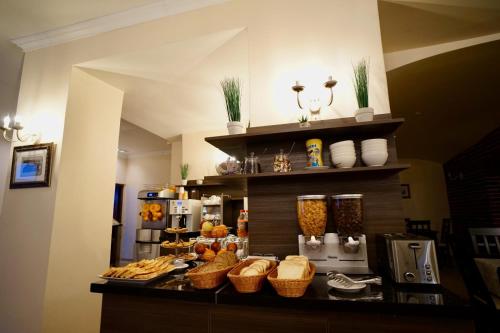 a bakery with a counter with baskets of food at Astoria Hotel & SPA in Hunedoara