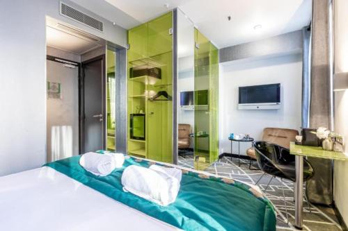 a bedroom with a bed and a green wall at Sublim by Sweett in Paris
