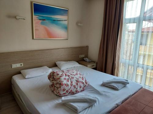 a bedroom with a bed with a pillow on it at Larsens Suit Hotel in Alanya