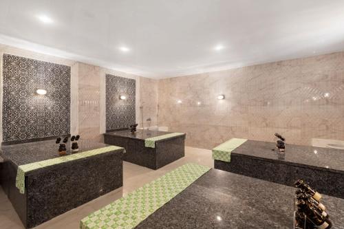 a large bathroom with two sinks and a shower at Pickalbatros Blu Spa Resort - Adults Friendly 16 Years Plus- Ultra All-Inclusive in Hurghada