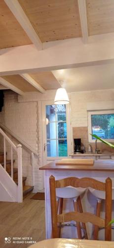 une cuisine avec un comptoir et une table avec des chaises dans l'établissement Maison cosy à Quiberville - Idéal pour familles, à Quiberville