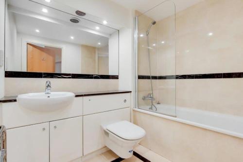 a bathroom with a toilet and a sink and a shower at Excel London City Airport Seagull Lane Royal Victoria 2 Bedrooms Apartments in London