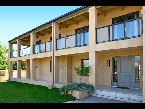 a large building with a door and a yard at Small Wonder in Franschhoek