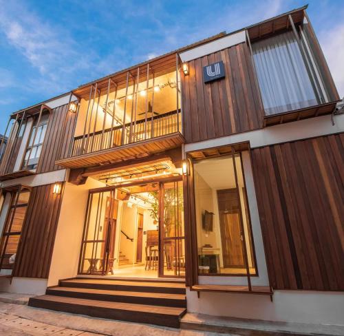 a house with large windows and a balcony at U chaikhong in Chiang Khan