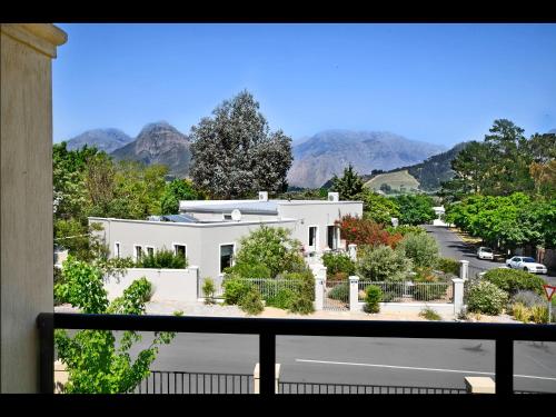 a view of a white house from a balcony at Small Wonder in Franschhoek