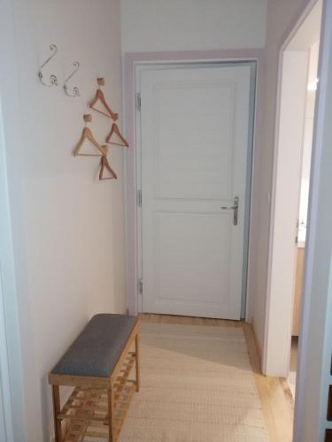 a room with a door and a bench in front of it at LES JARDINS CELESTES in Saint-Genest-de-Bauzon