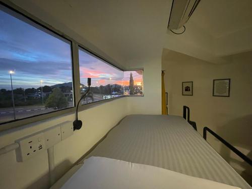 a bedroom with a bed and a large window at IM Santai Lodge in Kangar